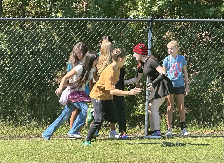 a group of kids chasing each other outside