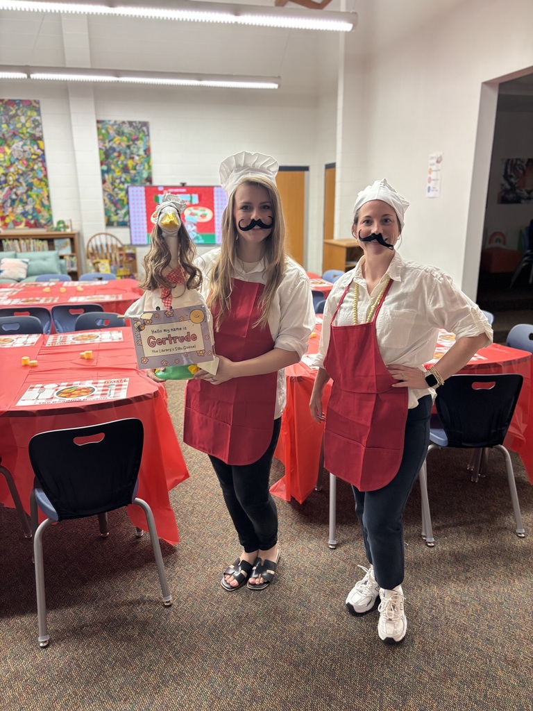 Teachers dressed in Italian restaurant clothing. Library decorated in Italian theme.