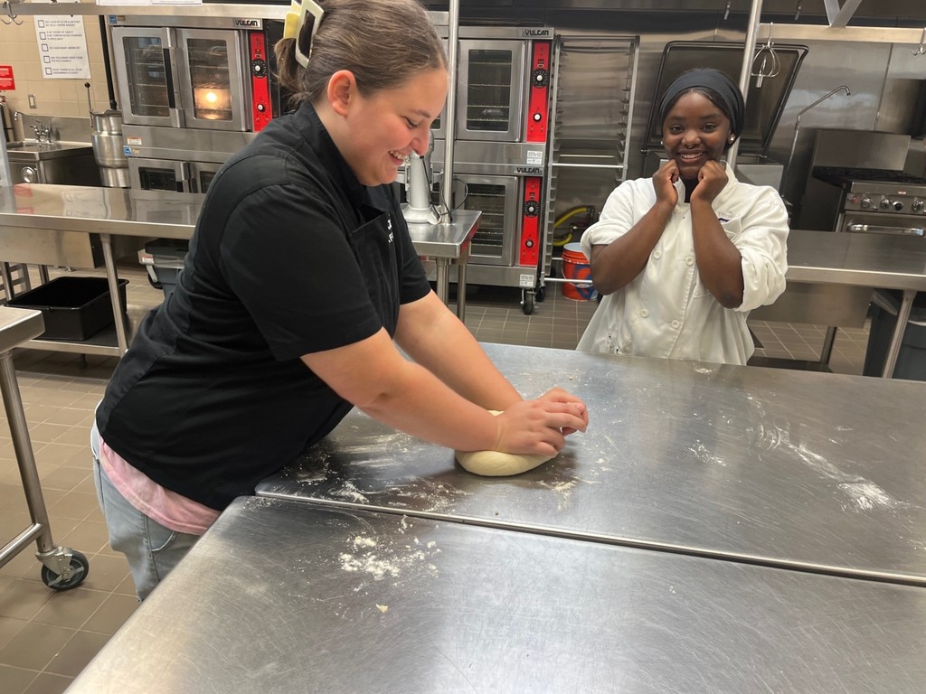 culinary student kneading dough