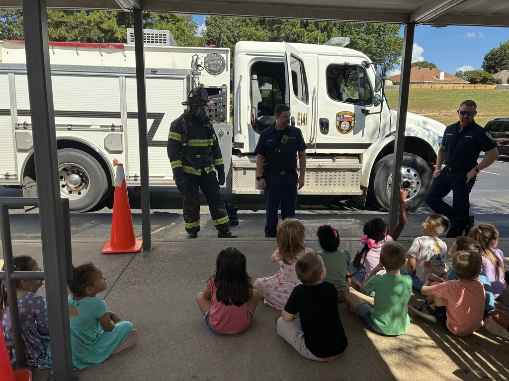 Firemen talking to a group of students.