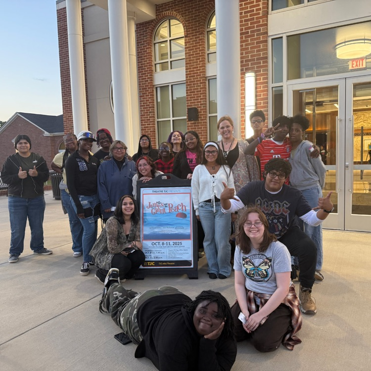 students with the play sign