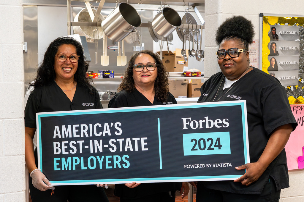 Bonner Elementary Food Services Team holding the Forbes America's Best-In-State Employers sign.