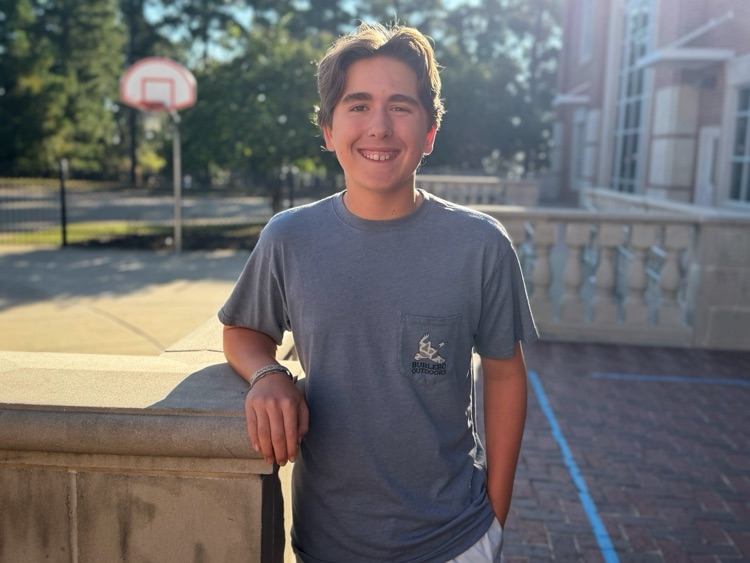 A student standing in the courtyard.
