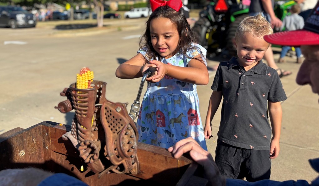 students shelling corn