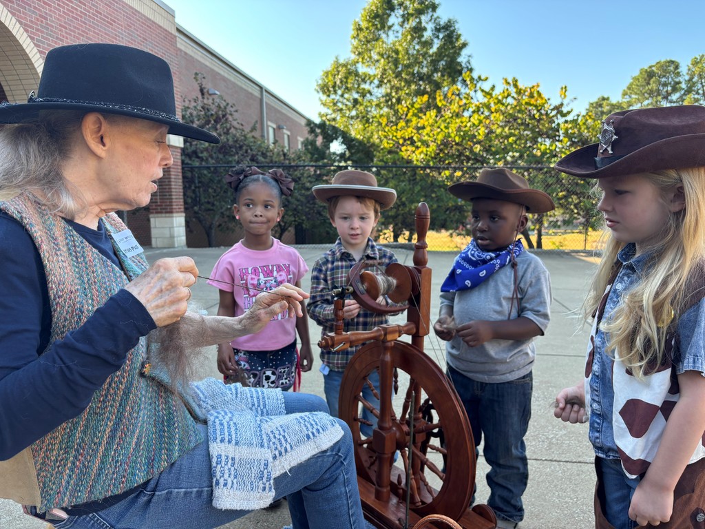 students learning how to spin llama hair