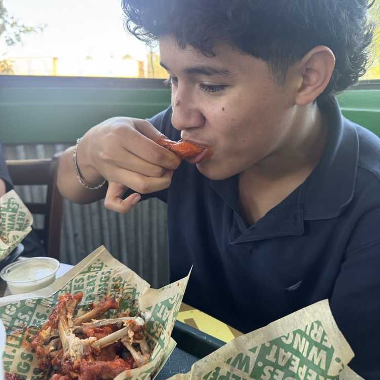 student eating wings
