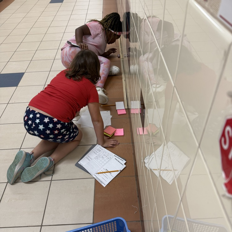 students completing a force in motion experiment with hot wheels no cards and sticky notes