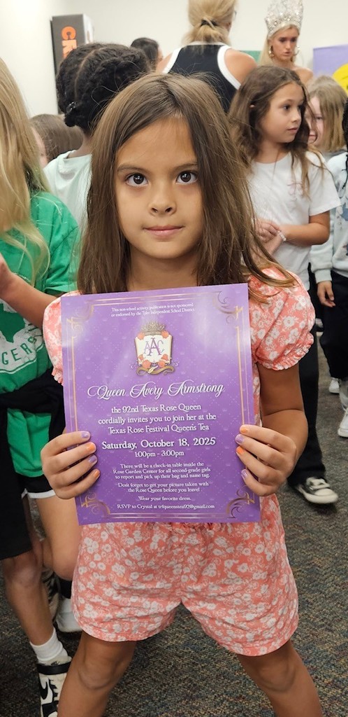 student holding an invitation to the queens tea