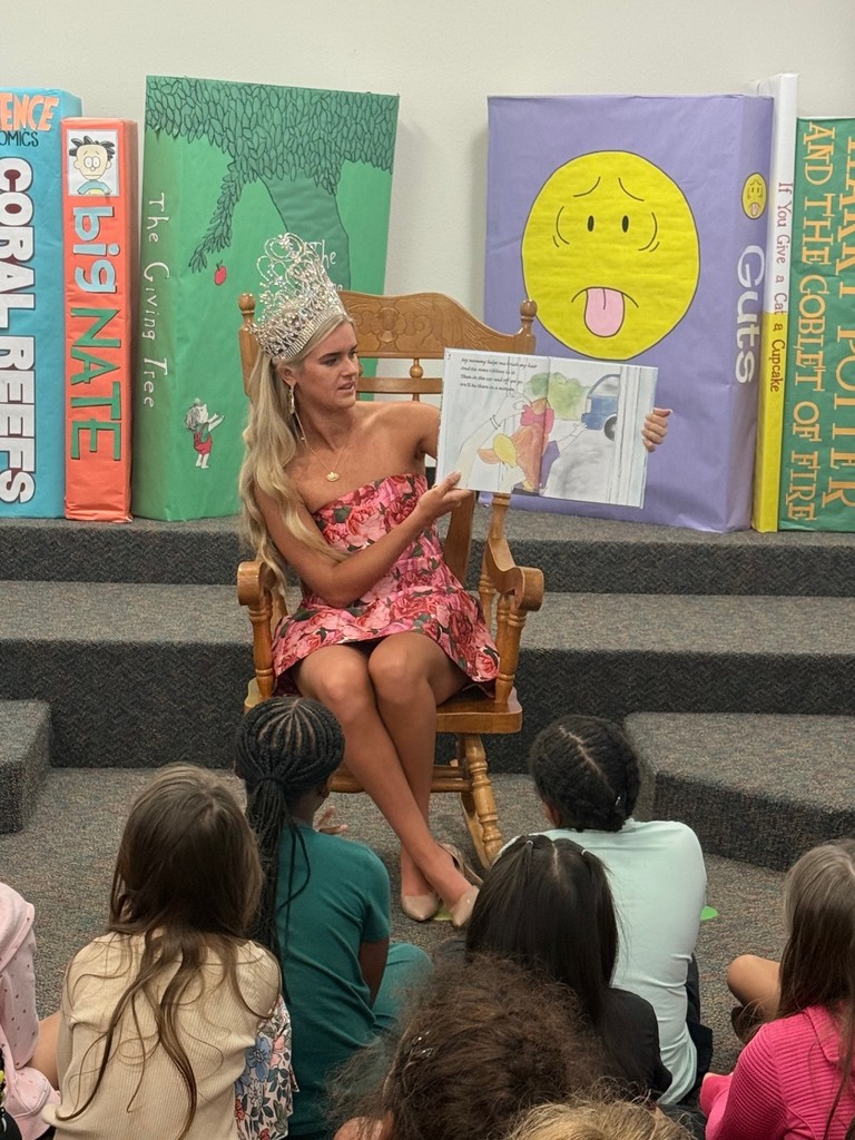 queen reading a book