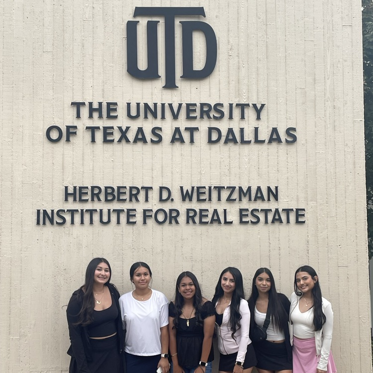 students in front of sign