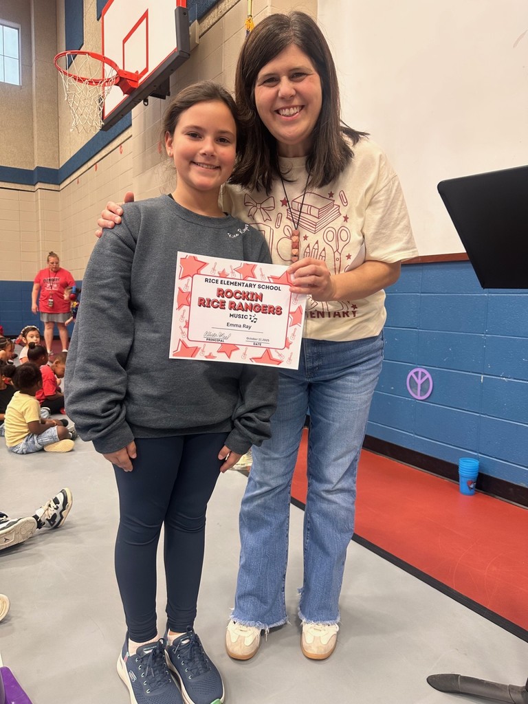 student and teacher with award