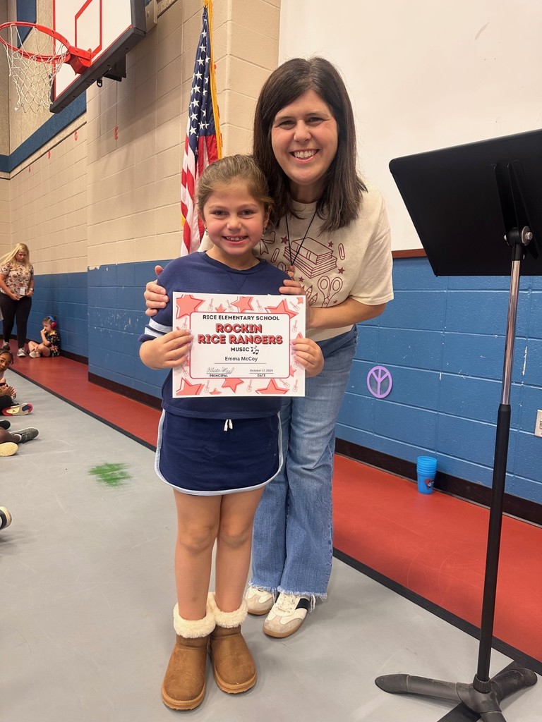 student and teacher with award