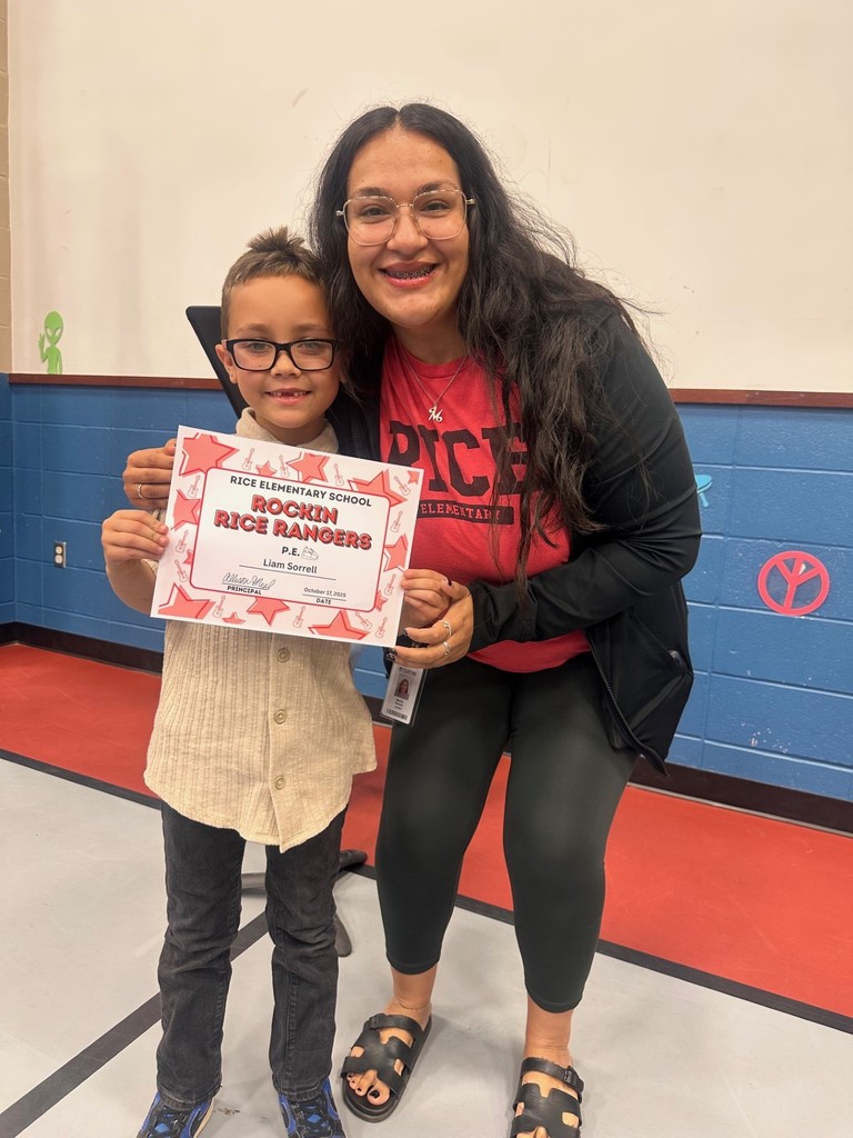 student and teacher with award