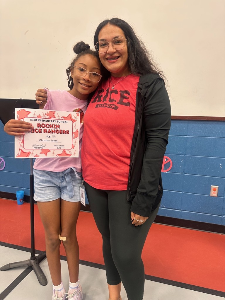student and teacher with an award