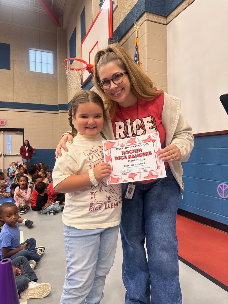student and teacher with award