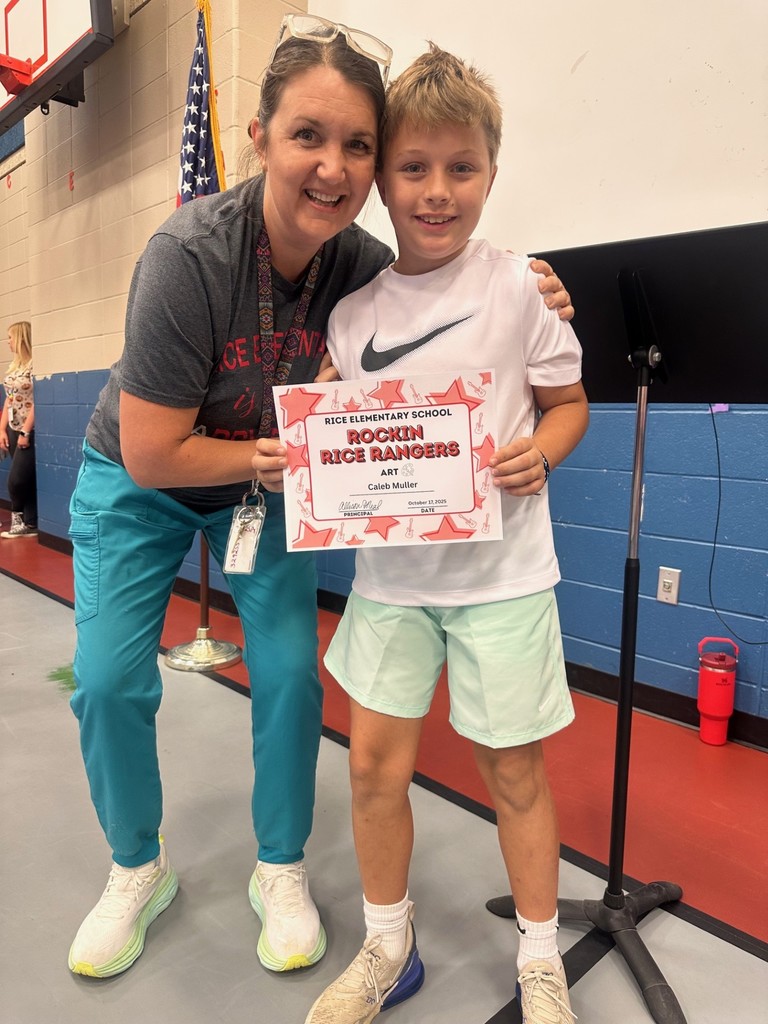 student and teacher with award