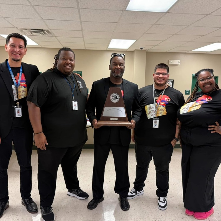 band instructors holding trophy