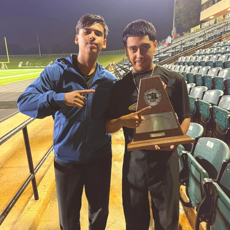 two students holding trophy