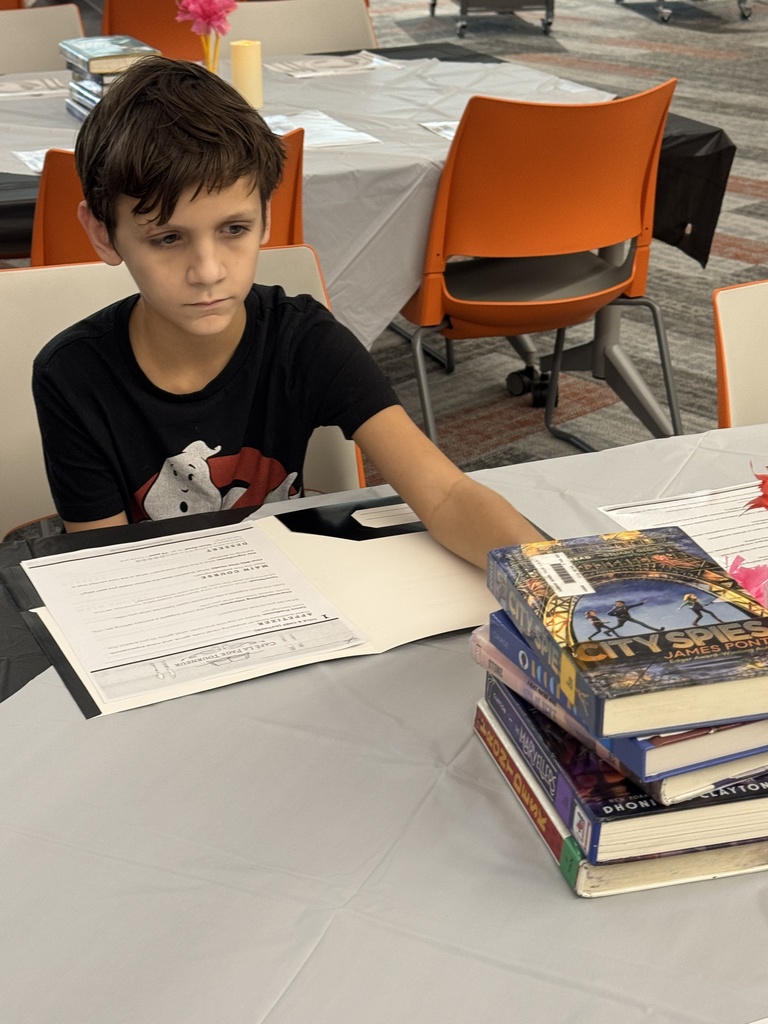 student selecting a book for his book tasting