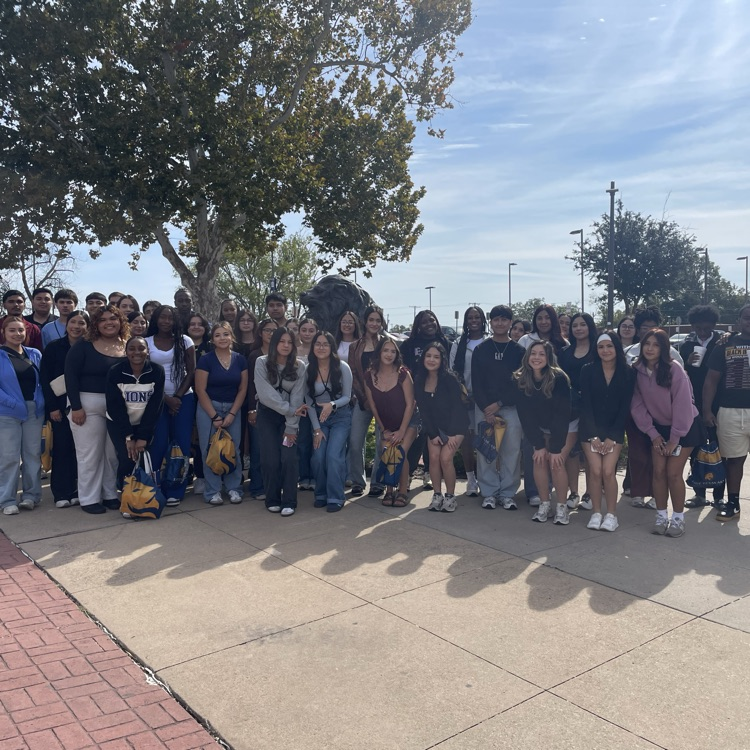 students in front of lion