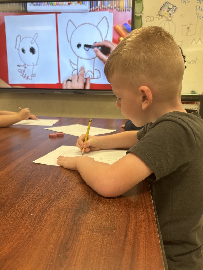 Students drawing using shapes.