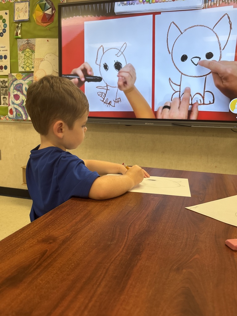 Students drawing using shapes.