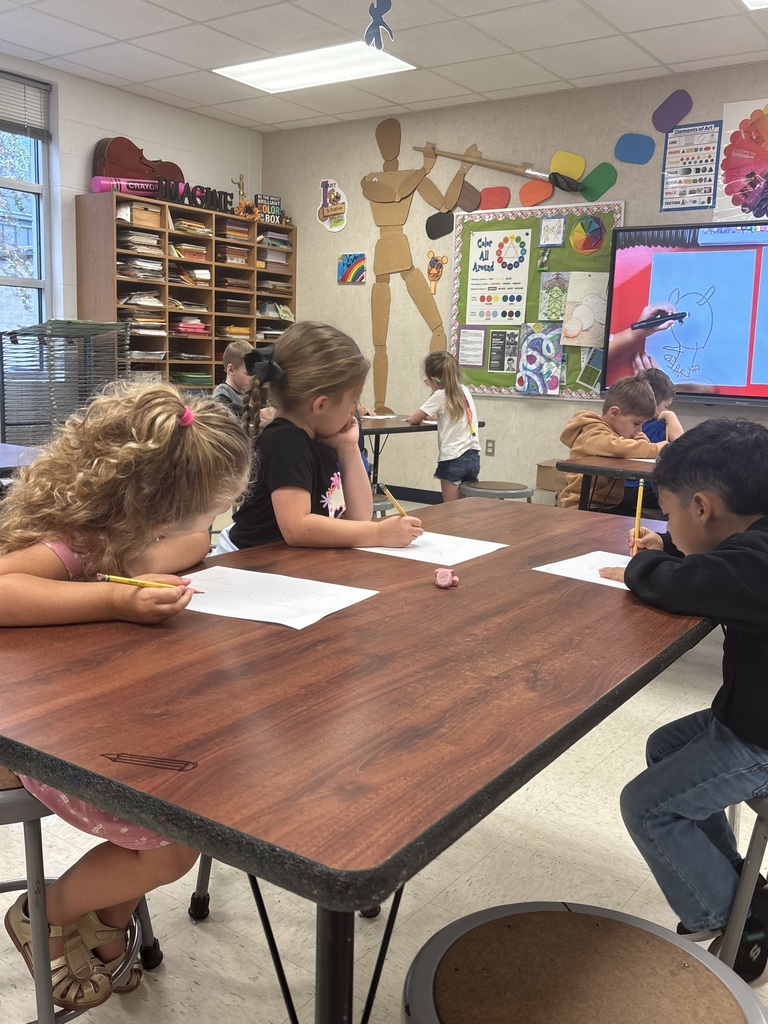 Students drawing using shapes.