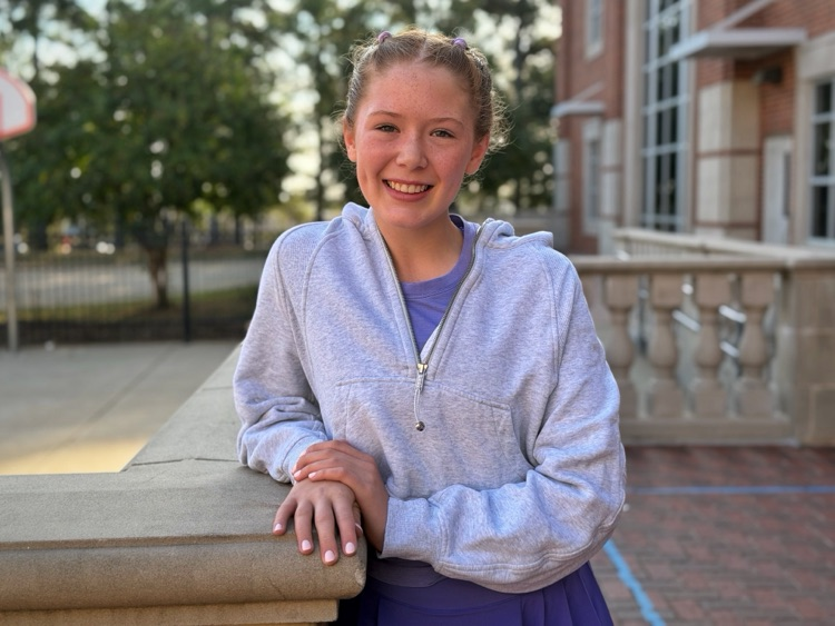 A student standing in the courtyard.