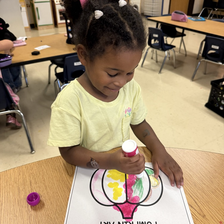 student completing pumpkin art