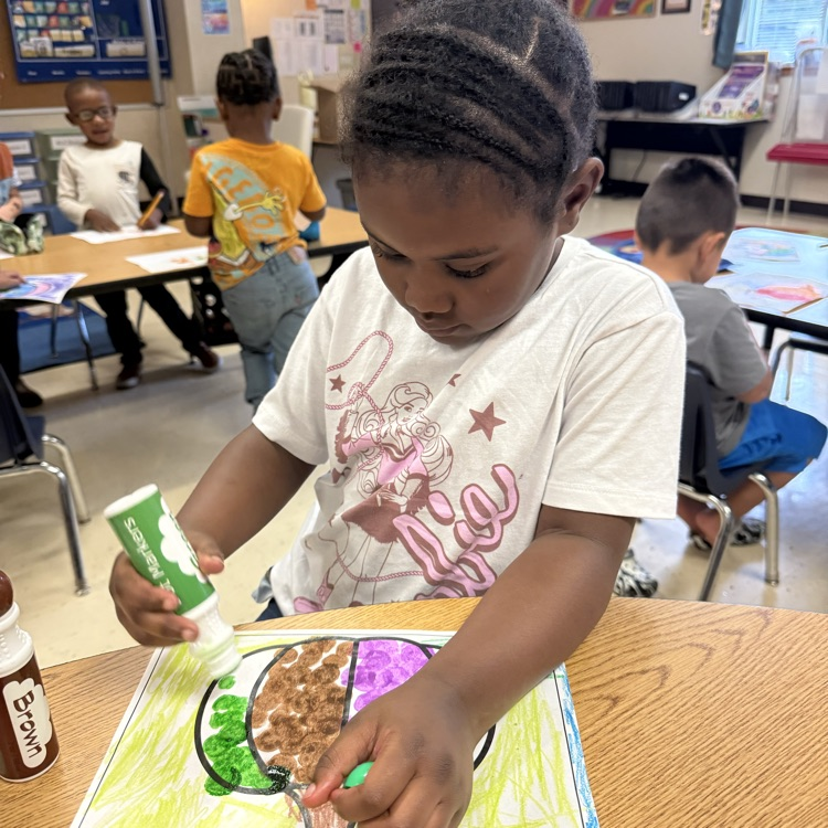 Student completing pumpkin art