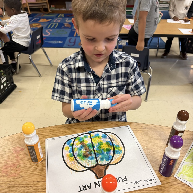 Student completing pumpkin art