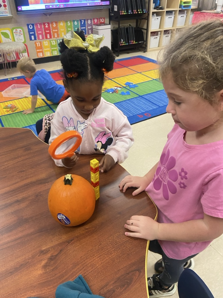 Kids doing pumpkin activities.