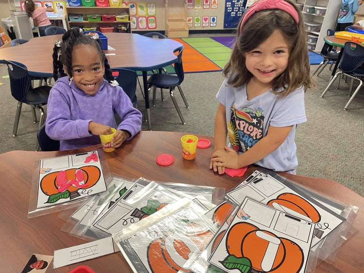 Kids doing pumpkin activities.