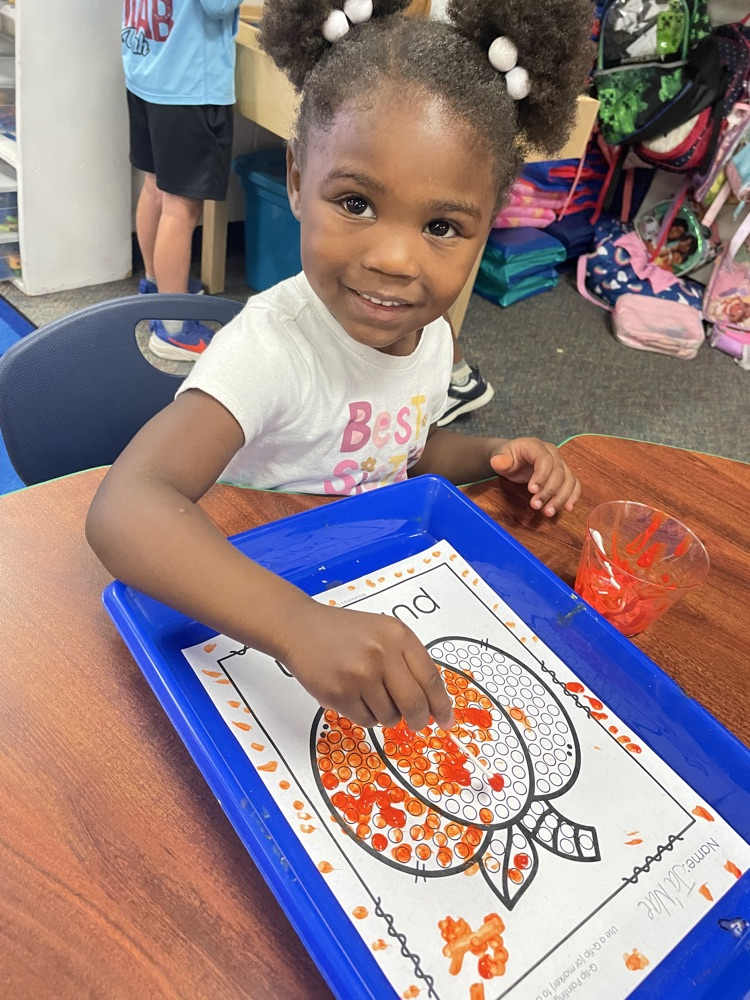 Kids doing pumpkin activities.