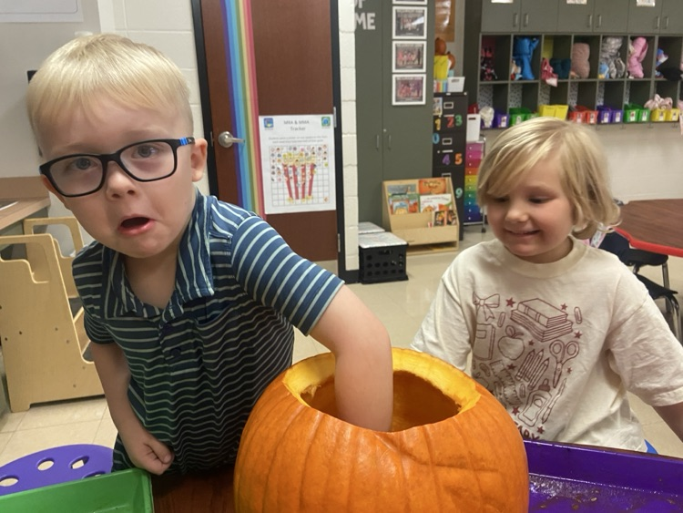 Kids doing pumpkin activities.