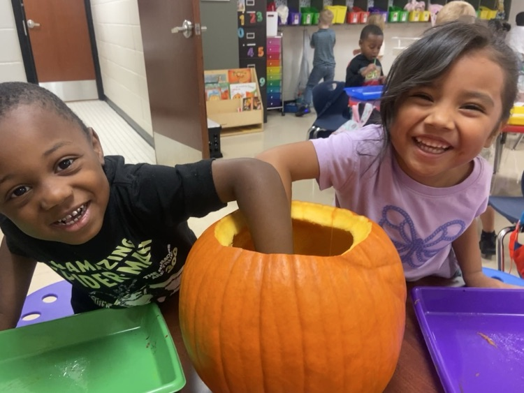 Kids doing pumpkin activities.