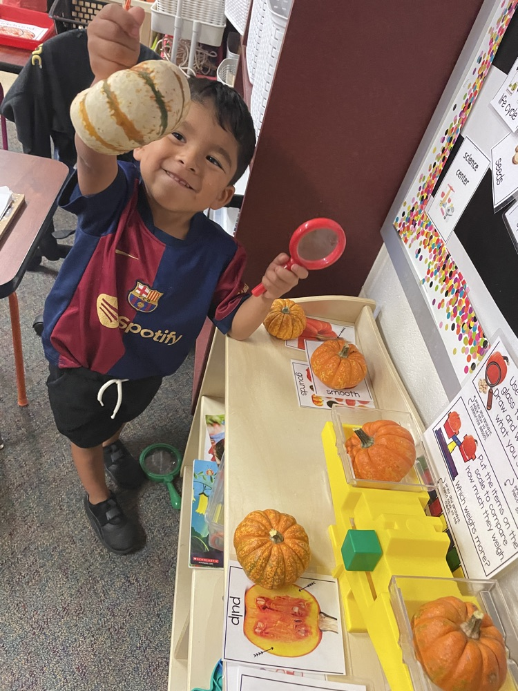 Kids doing pumpkin activities.