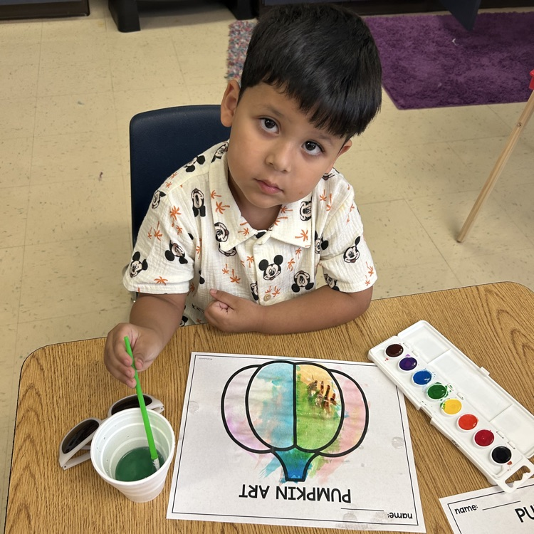 students completing pumpkin art painting