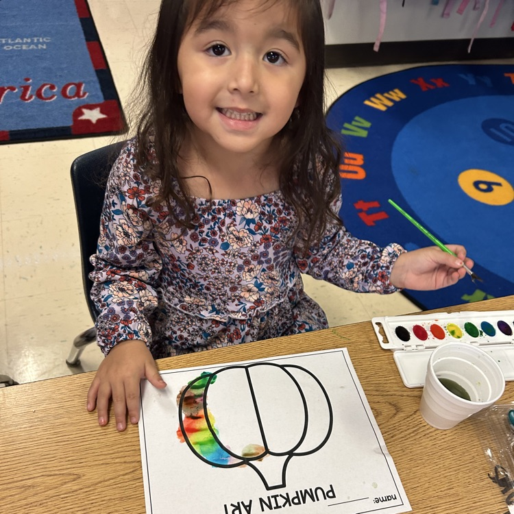 students completing pumpkin art painting