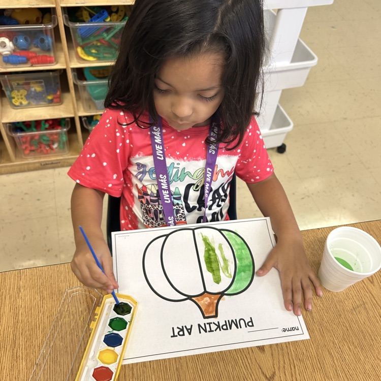 students completing pumpkin art painting