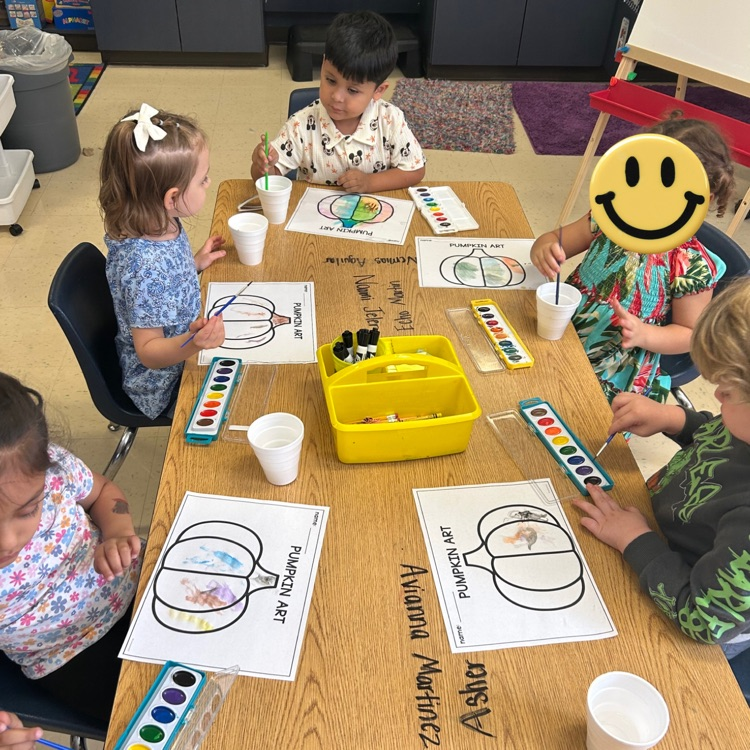 students completing pumpkin art