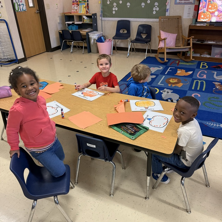 students working at tables completing pumpkin art