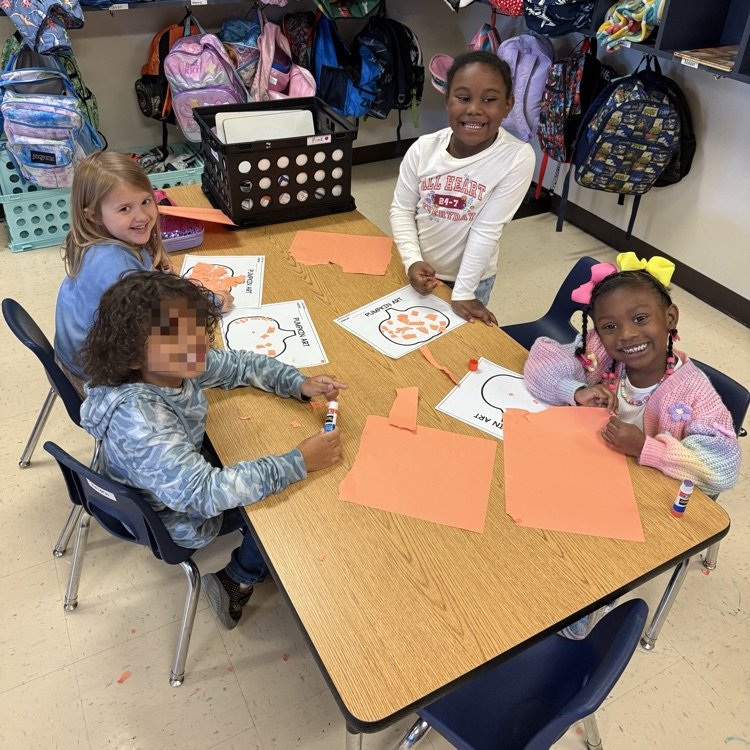 students working at tables completing pumpkin art