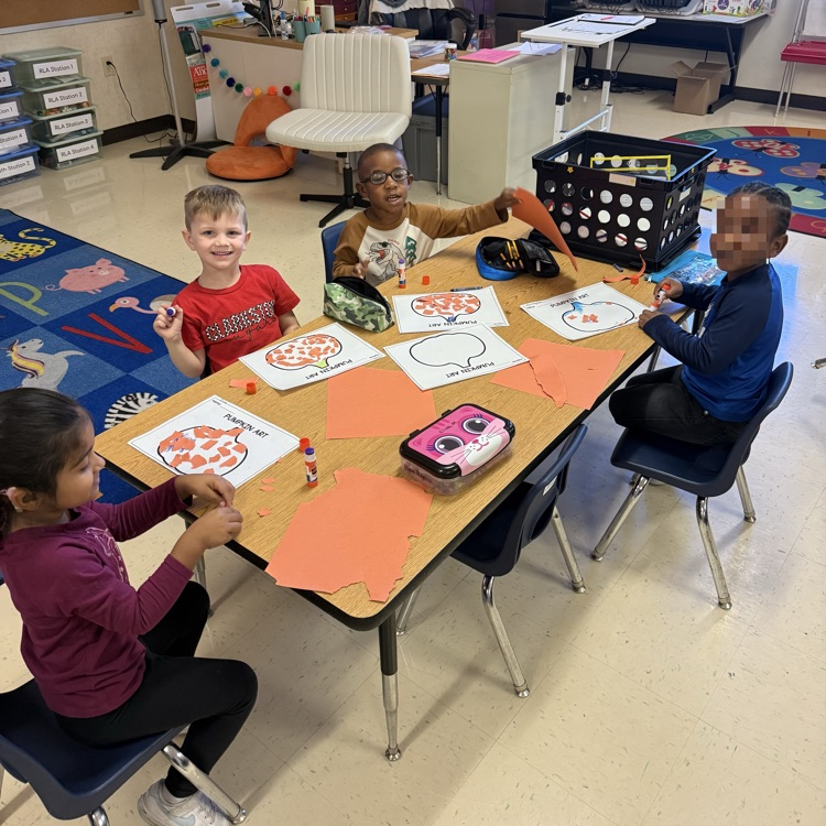 students working at tables completing pumpkin art