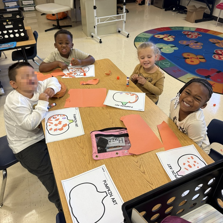 students working at tables completing pumpkin art