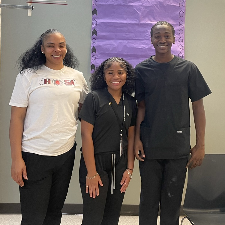 three people posing for picture