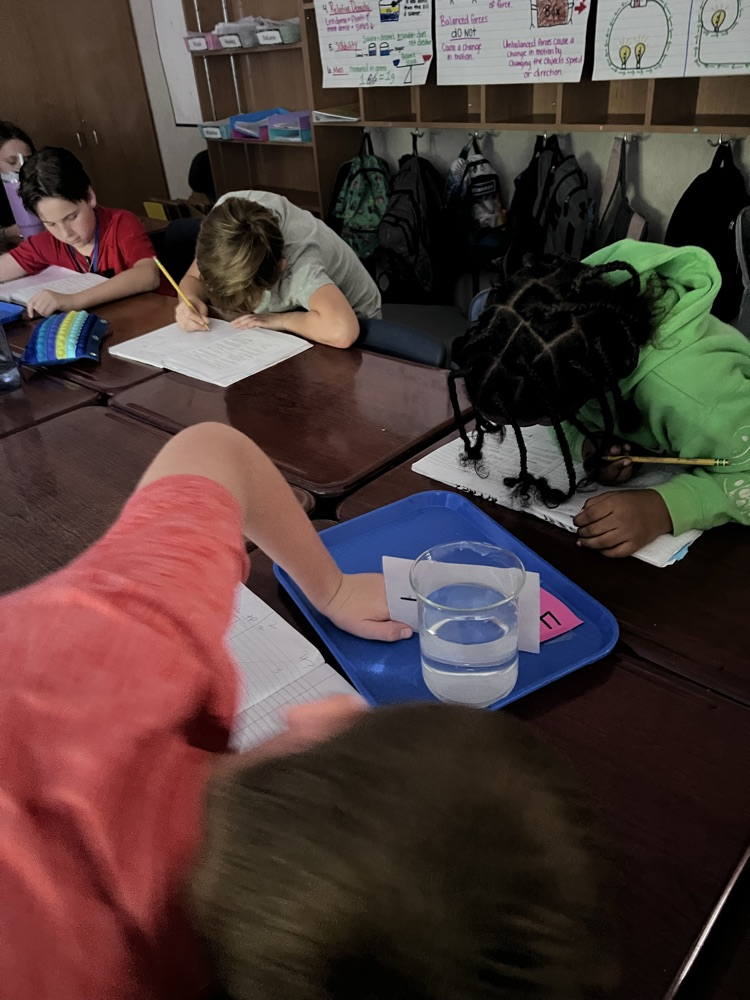 students doing experiments with flashlights