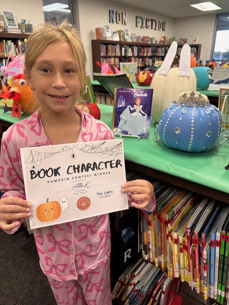 Girl with decorated pumpkin and certificate