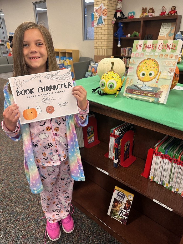 Girl with decorated pumpkin and certificate