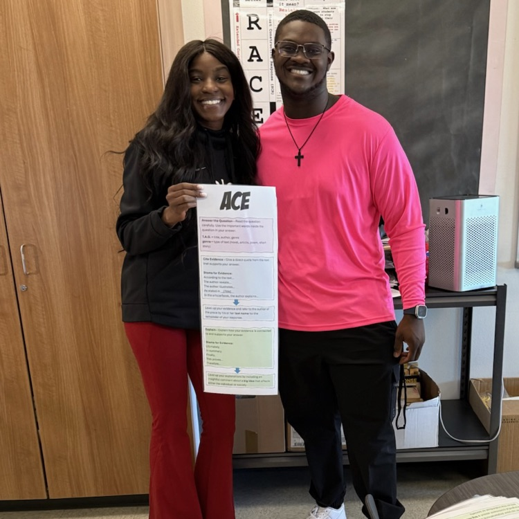 two people holding a poster